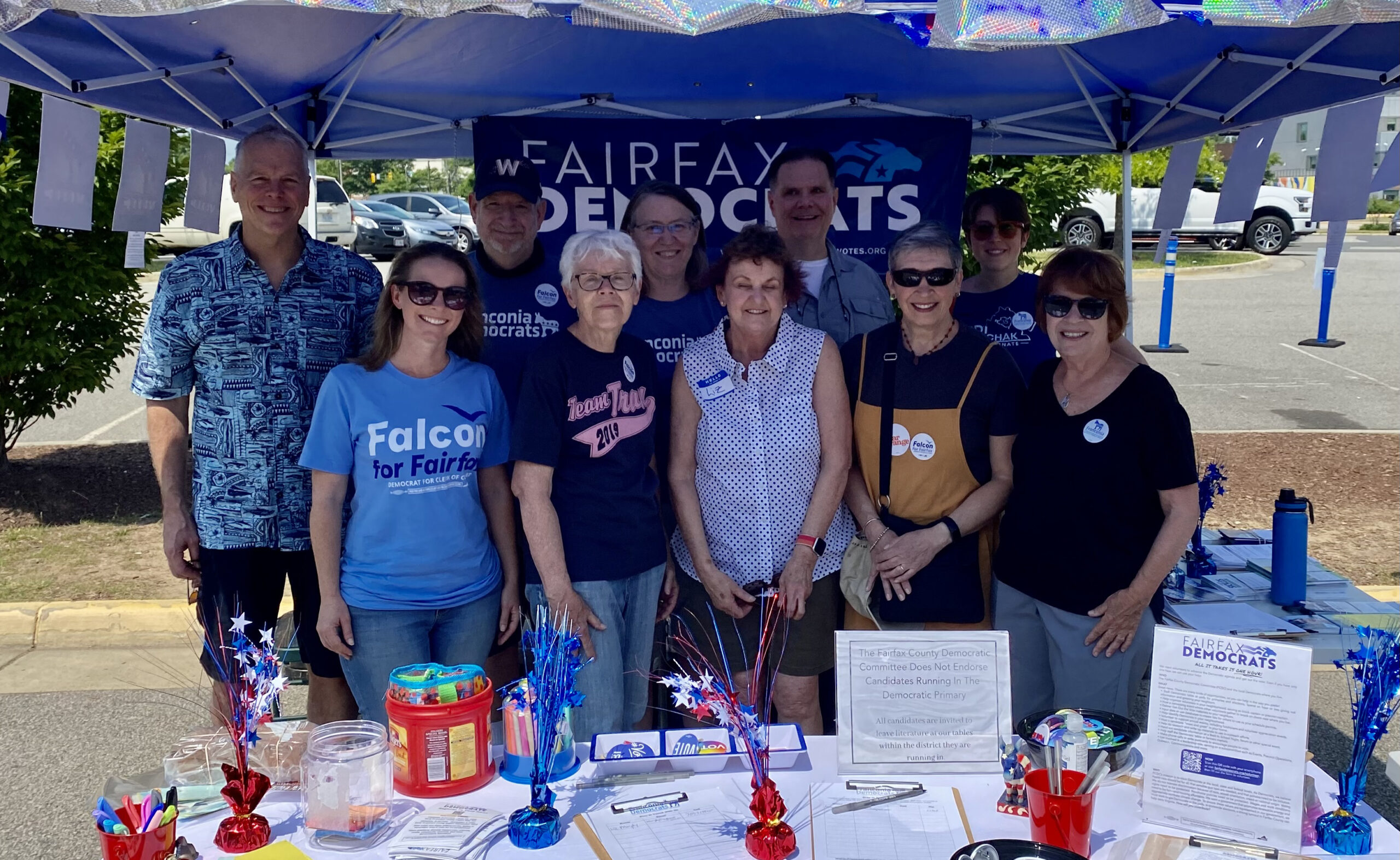 group of people at table with Fairfax Democrats sign in background