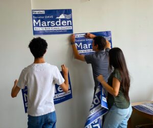 Staffers putting up Marsden posters.